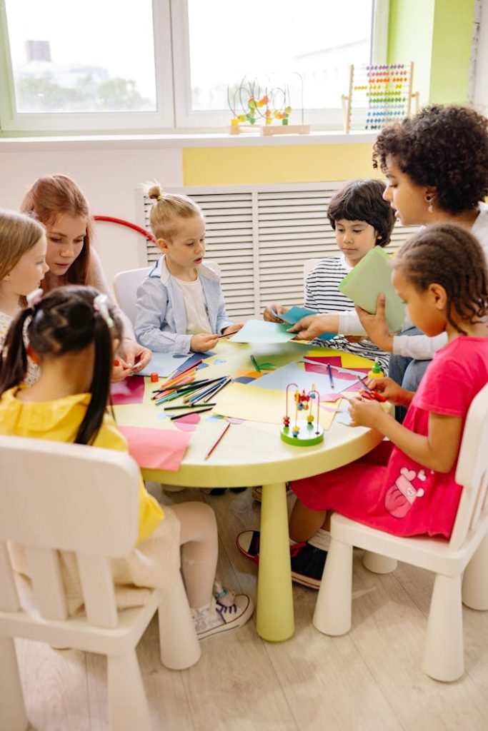 children-sitting-on-chairs-in-front-of-table-with-art-materials-8613059 Children engaged in creative activities during an art at a preschool, fostering learning and fun.